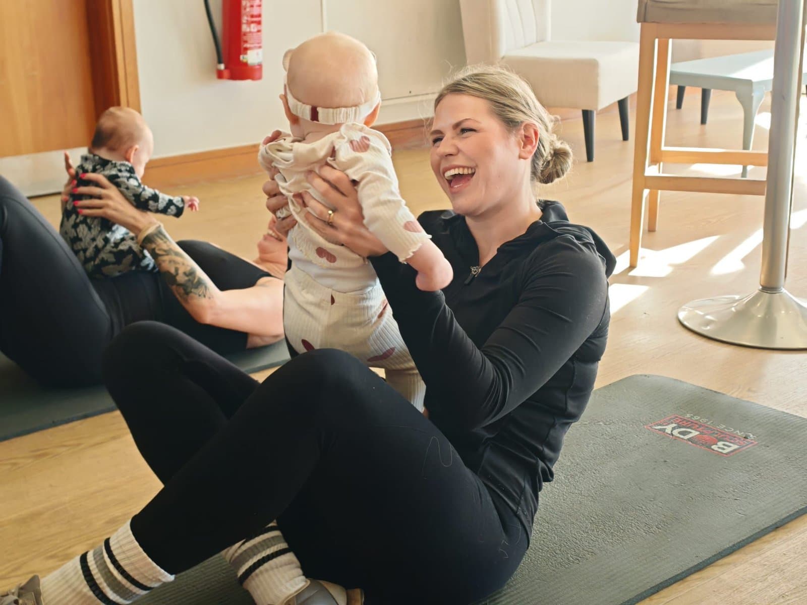 Parents holding their babies during a Startstrong Fitness CIC class