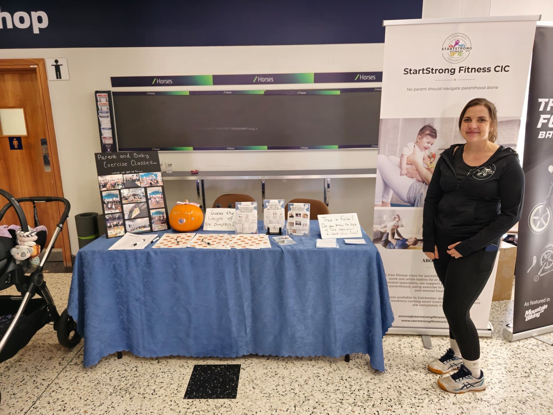 Startstrong Fitness CIC community event stand with parents and families
