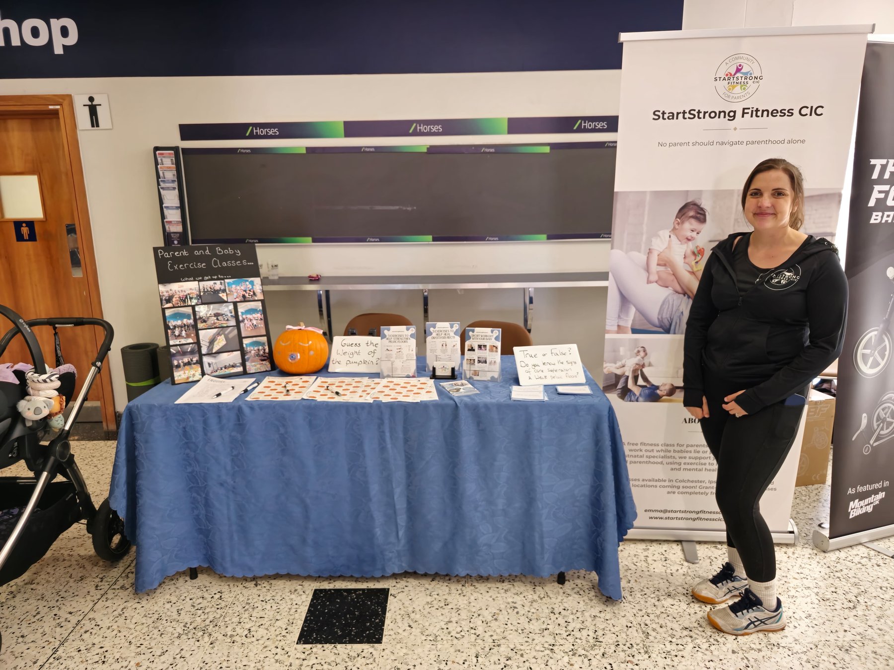 Startstrong Fitness CIC community event stand with parents and families